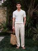 Man wearing the VAËL Seréno drawstring linen trousers