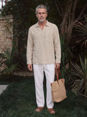 Man wearing the VAËL Solano open-collar linen shirt in beige