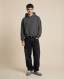 Man wearing the VAËL Varēk cropped cotton hooded sweatshirt