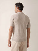 Man wearing the VAËL Isídro slim-fit knit polo in oat