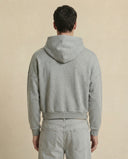 Man wearing the VAËL Varēk cropped cotton hooded sweatshirt