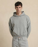 Man wearing the VAËL Varēk cropped cotton hooded sweatshirt