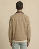 Man wearing the VAËL Cadré canvas workwear jacket with leather collar