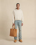 Man wearing the VAËL Varēk cropped cotton hooded sweatshirt
