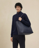 Man wearing the VAËL Caël ribbed half-zip wool sweater