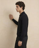 Man wearing the VAËL Vālen fine wool half-zip sweater