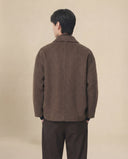 Man wearing the VAËL Aurēn wool wrap coat with enveloping collar