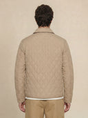Man wearing the VAËL Tēron lightweight quilted jacket
