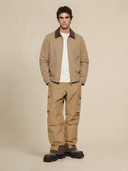 Man wearing the VAËL Cadré canvas workwear jacket with leather collar