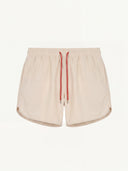 Man wearing the VAËL Lucéro swim shorts in terracotta