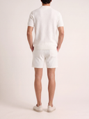Man wearing the VAËL Aurélio textured knit shorts in white