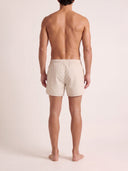 Man wearing the VAËL Lucéro swim shorts in terracotta