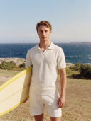 Man wearing the VAËL Aurélio open-collar knit polo in white
