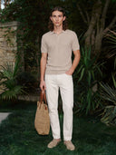 Man wearing the VAËL Isídro slim-fit knit polo in oat