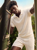 Man wearing the VAËL Aurélio open-collar knit polo in white