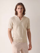 Man wearing the VAËL Marbella open-collar knit polo in warm ivory