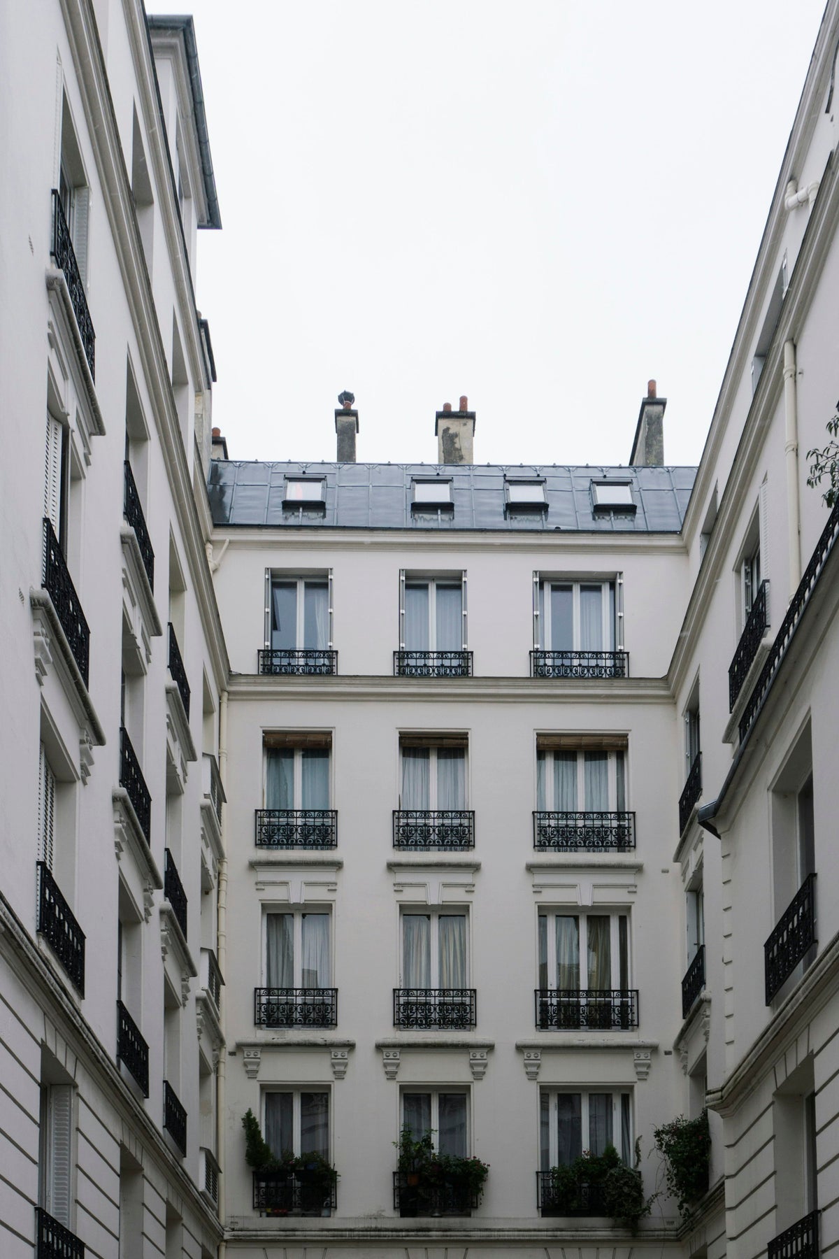White Paris facades around a courtyard, seen from below